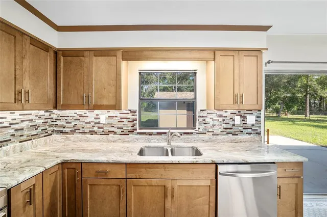a view of a kitchen with a sink and refrigerator