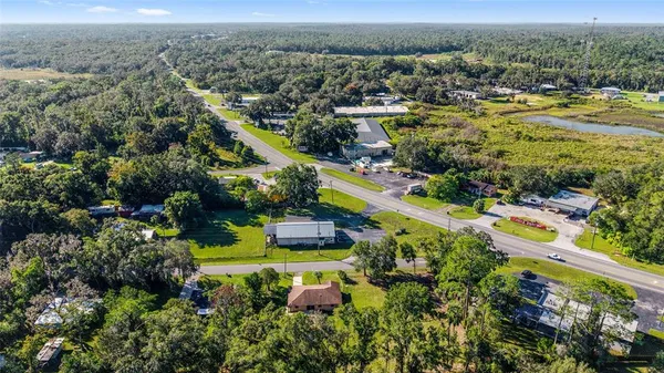 an aerial view of a house with a yard