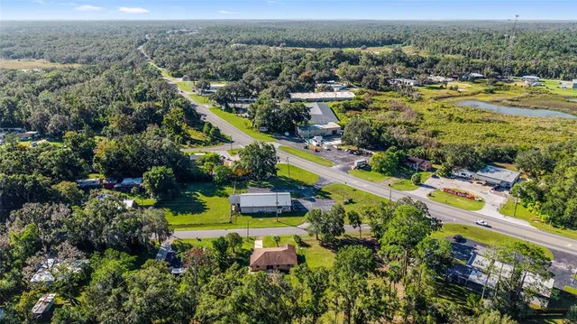 an aerial view of a house with a yard