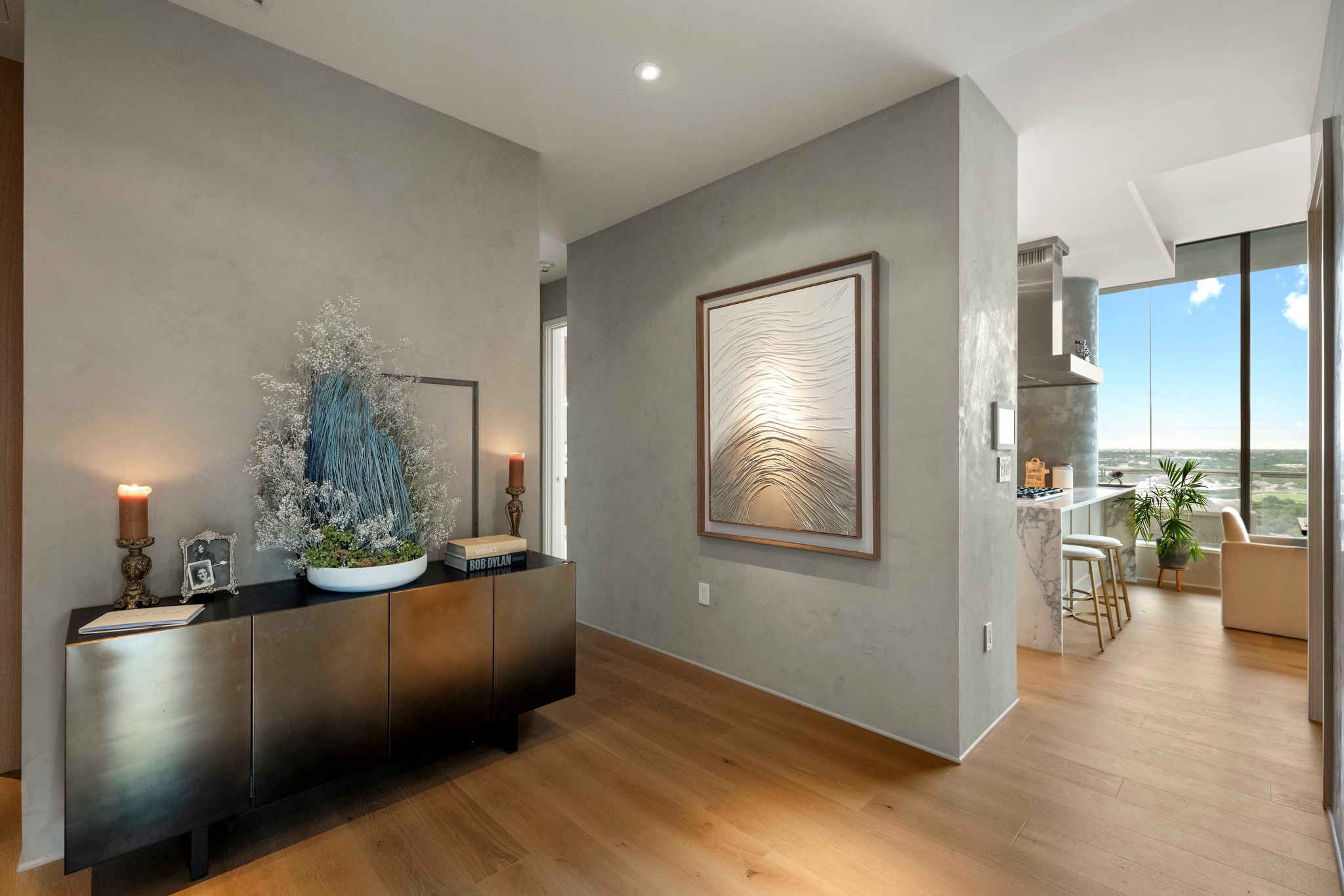 210 Lavaca Street, Unit 2706 Austin, TX 78701 - Photo 26 of 32 Hardwood flooring extending through the entry and into the living areas, featuring textured wall finishes and recessed lighting