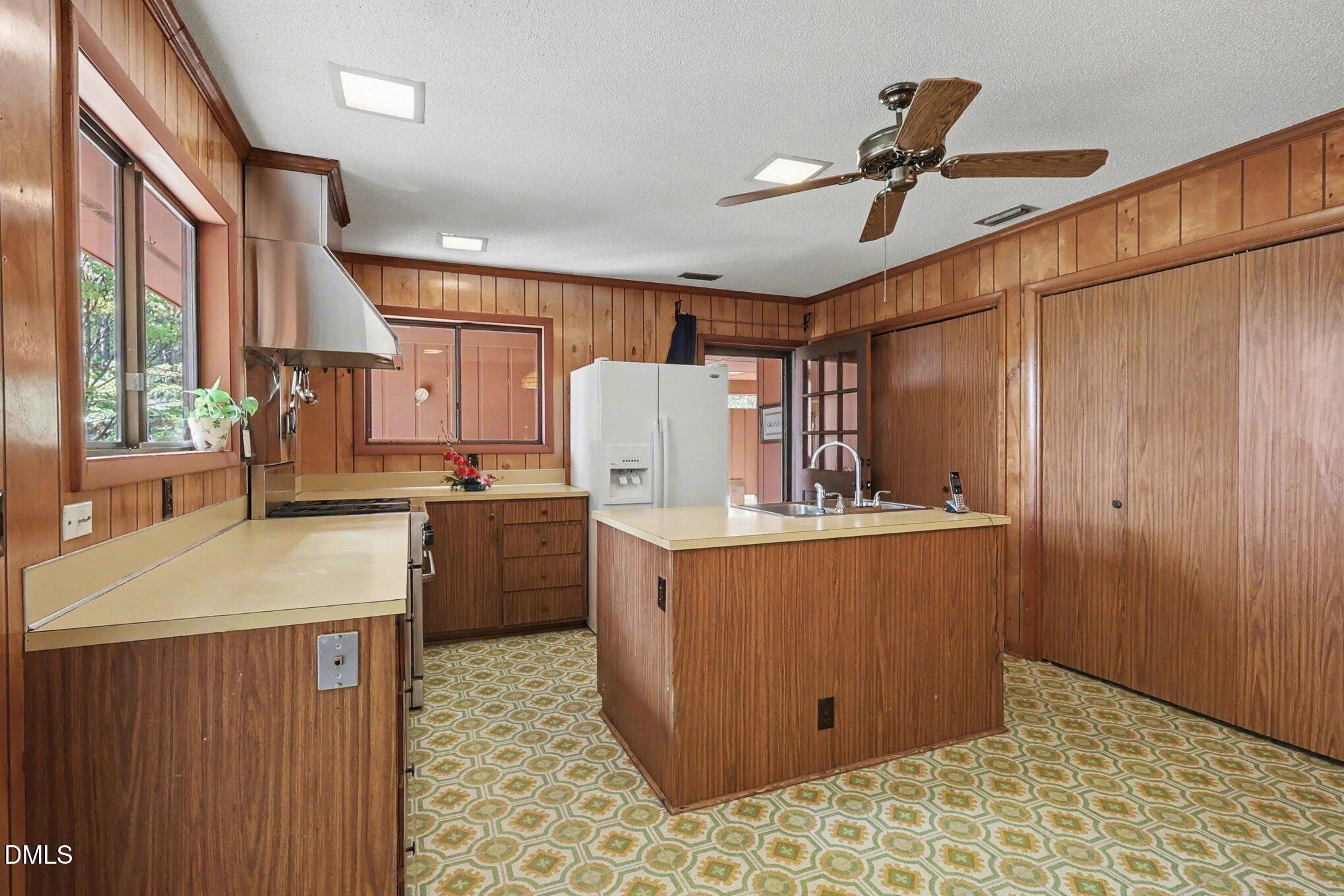 5702 Old Greensboro Road Chapel Hill, NC 27516 - Photo 15 of 43 a kitchen with a stove a refrigerator and a sink