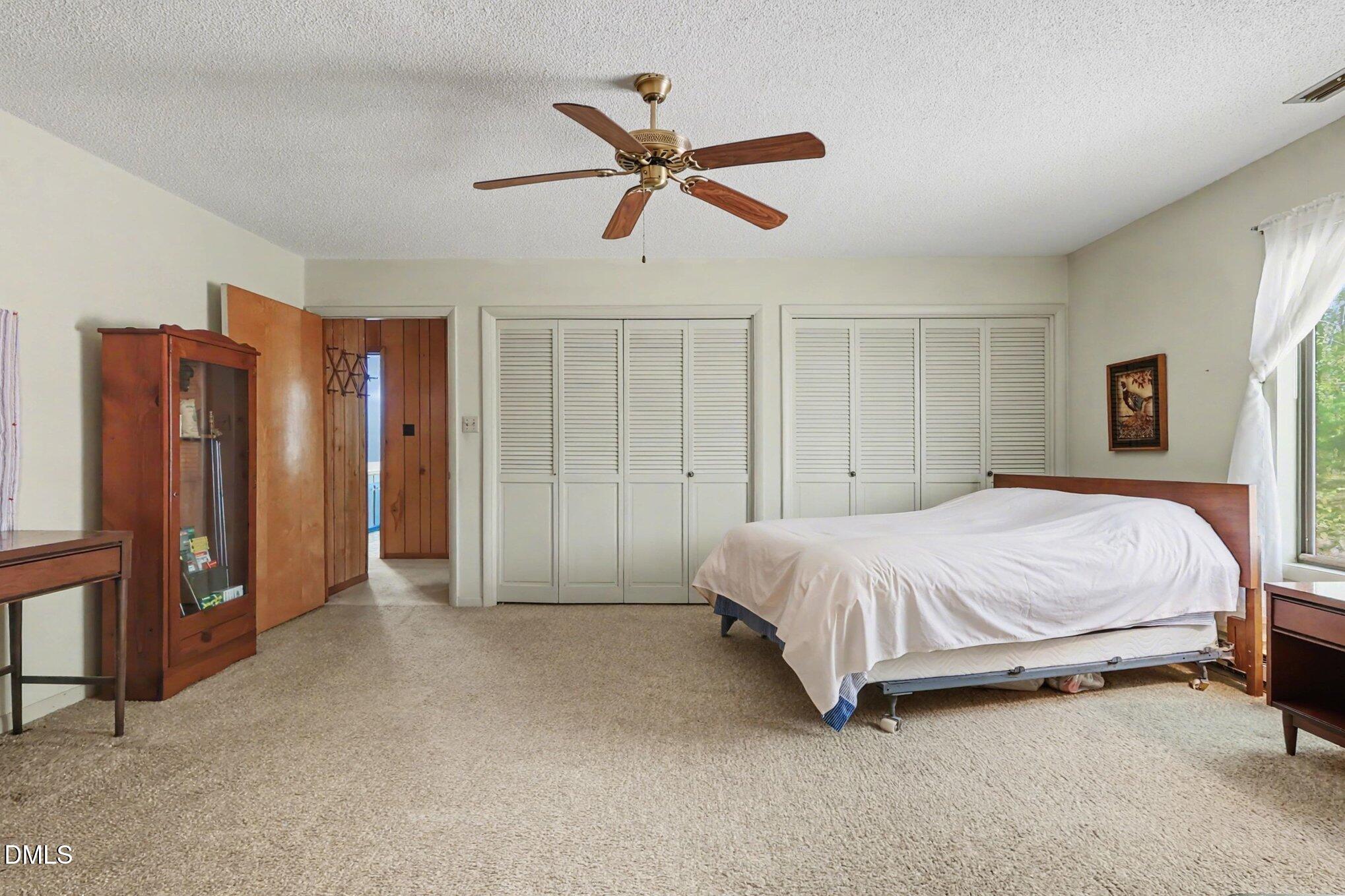 5702 Old Greensboro Road Chapel Hill, NC 27516 - Photo 21 of 43 a spacious bedroom with a bed and closet
