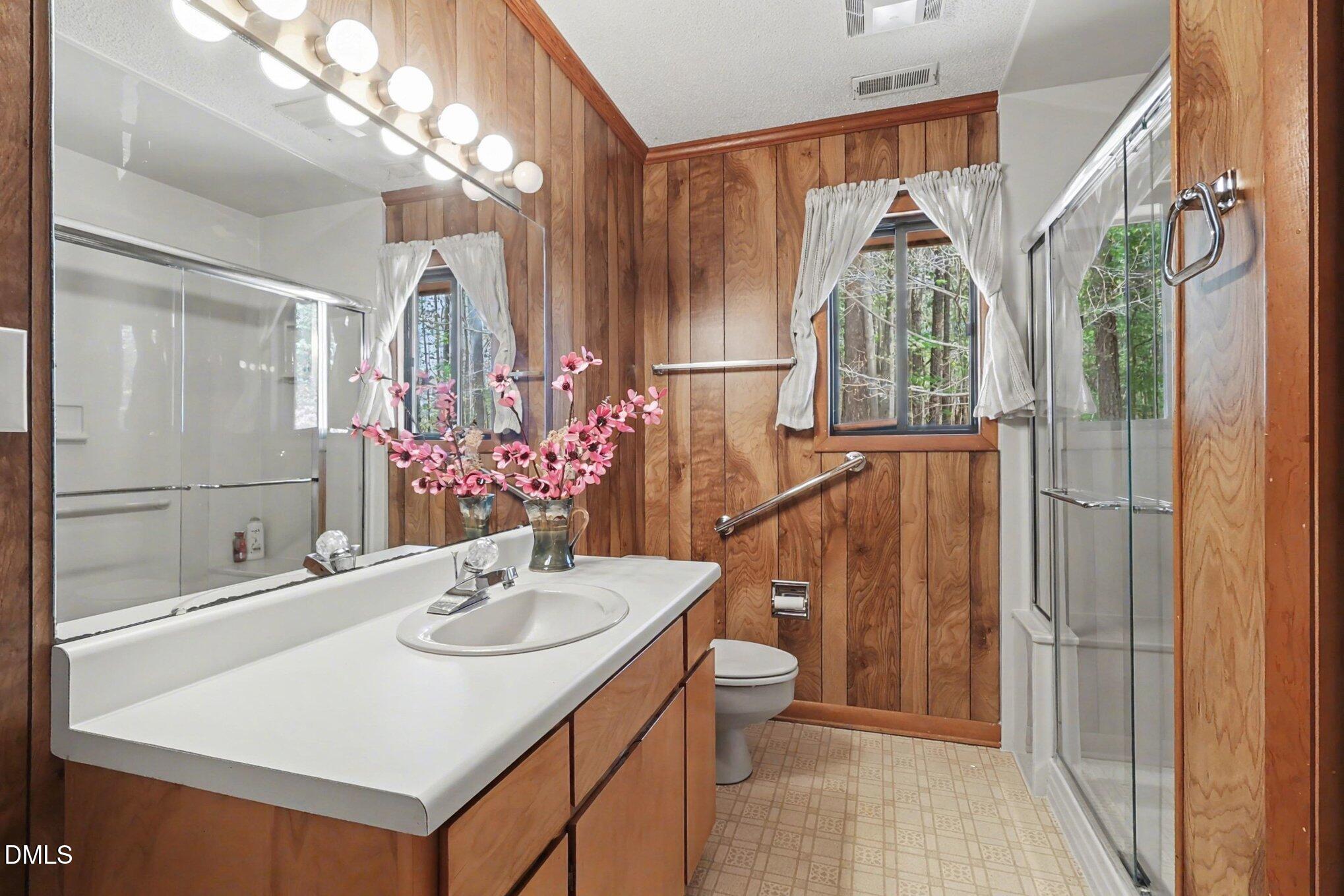 5702 Old Greensboro Road Chapel Hill, NC 27516 - Photo 27 of 43 a bathroom with a sink a toilet and a mirror