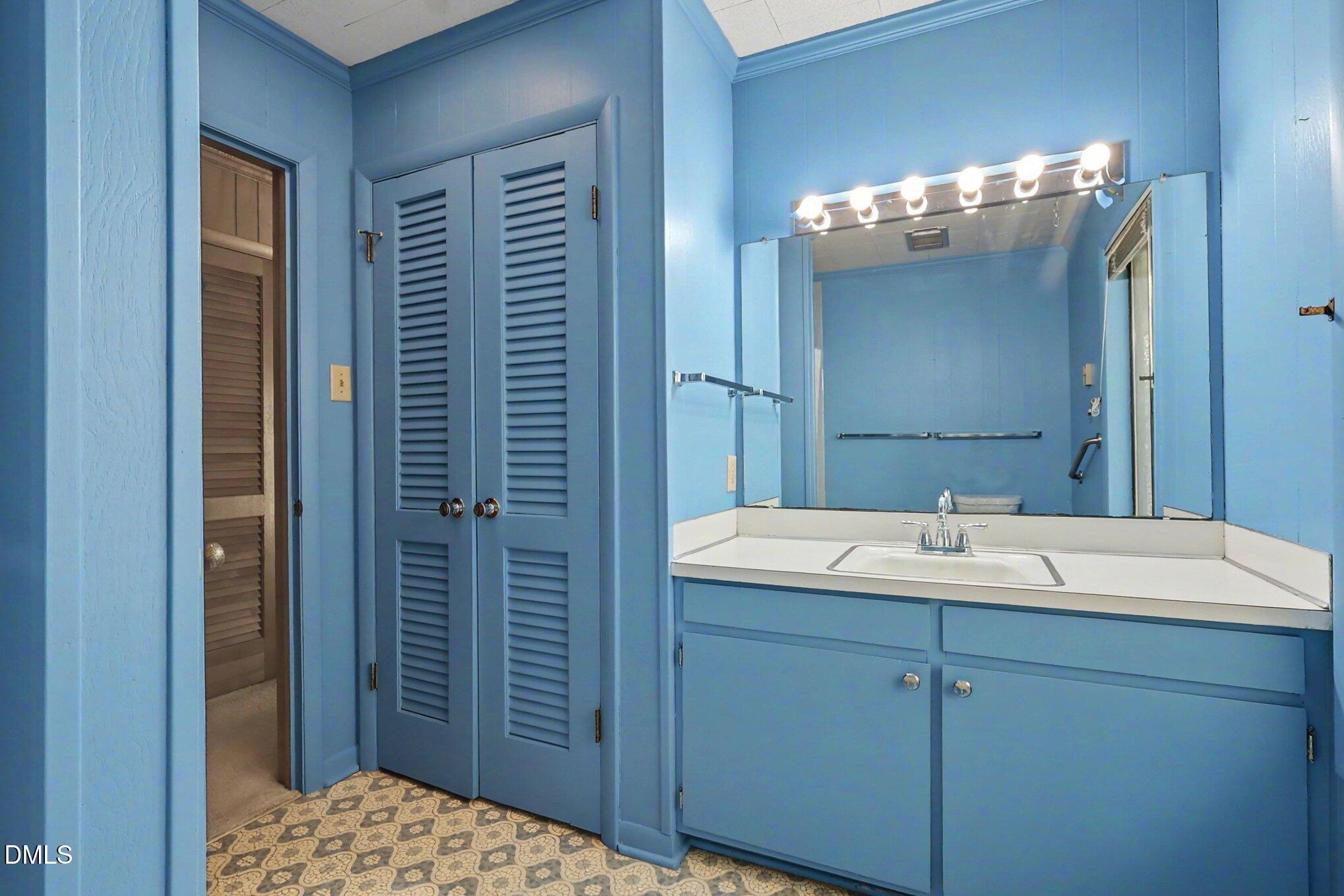 5702 Old Greensboro Road Chapel Hill, NC 27516 - Photo 28 of 43 a bathroom with a sink a mirror and shower