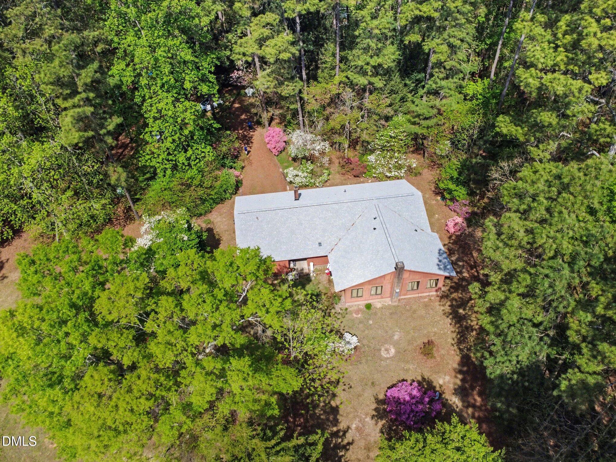 5702 Old Greensboro Road Chapel Hill, NC 27516 - Photo 32 of 43 an aerial view of a house with a yard and garden