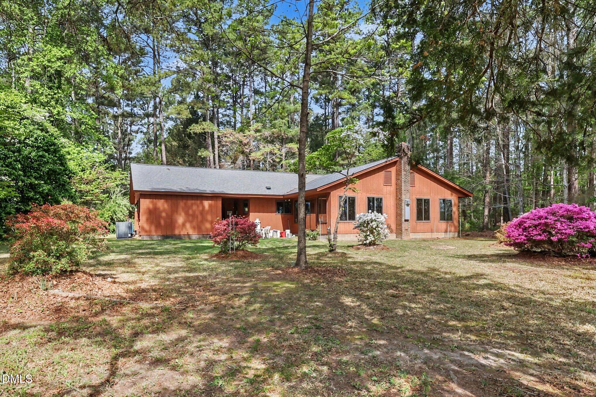 5702 Old Greensboro Road Chapel Hill, NC 27516 - Photo 5 of 43 a front view of a house with a garden