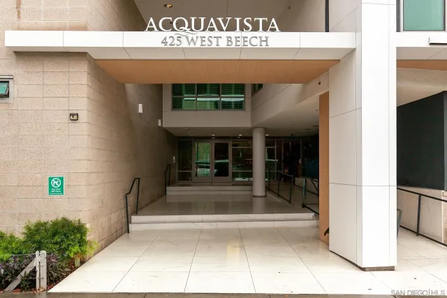 a view of a hallway with wooden floor and entryway