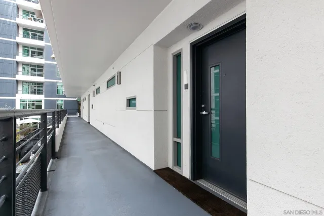 a living room with furniture a dining table and a refrigerator