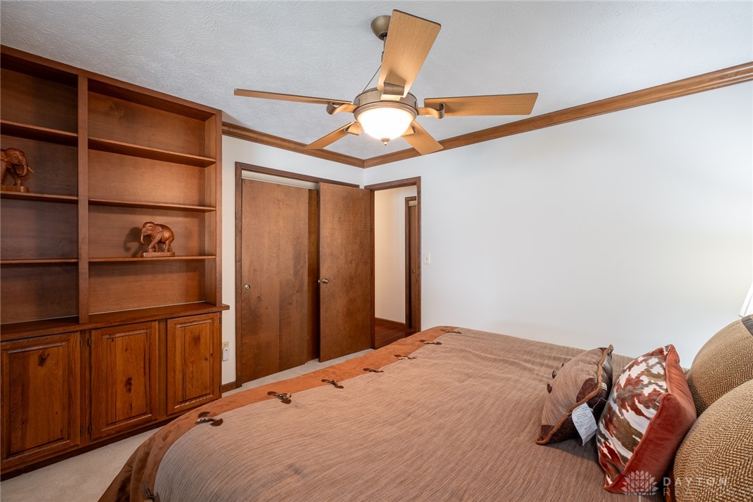 273 North Alpha Bellbrook Road Dayton, OH 45434 - Photo 29 of 43 This cozy bedroom features built-in shelving and soft carpeting, creating a comfortable and inviting atmosphere.