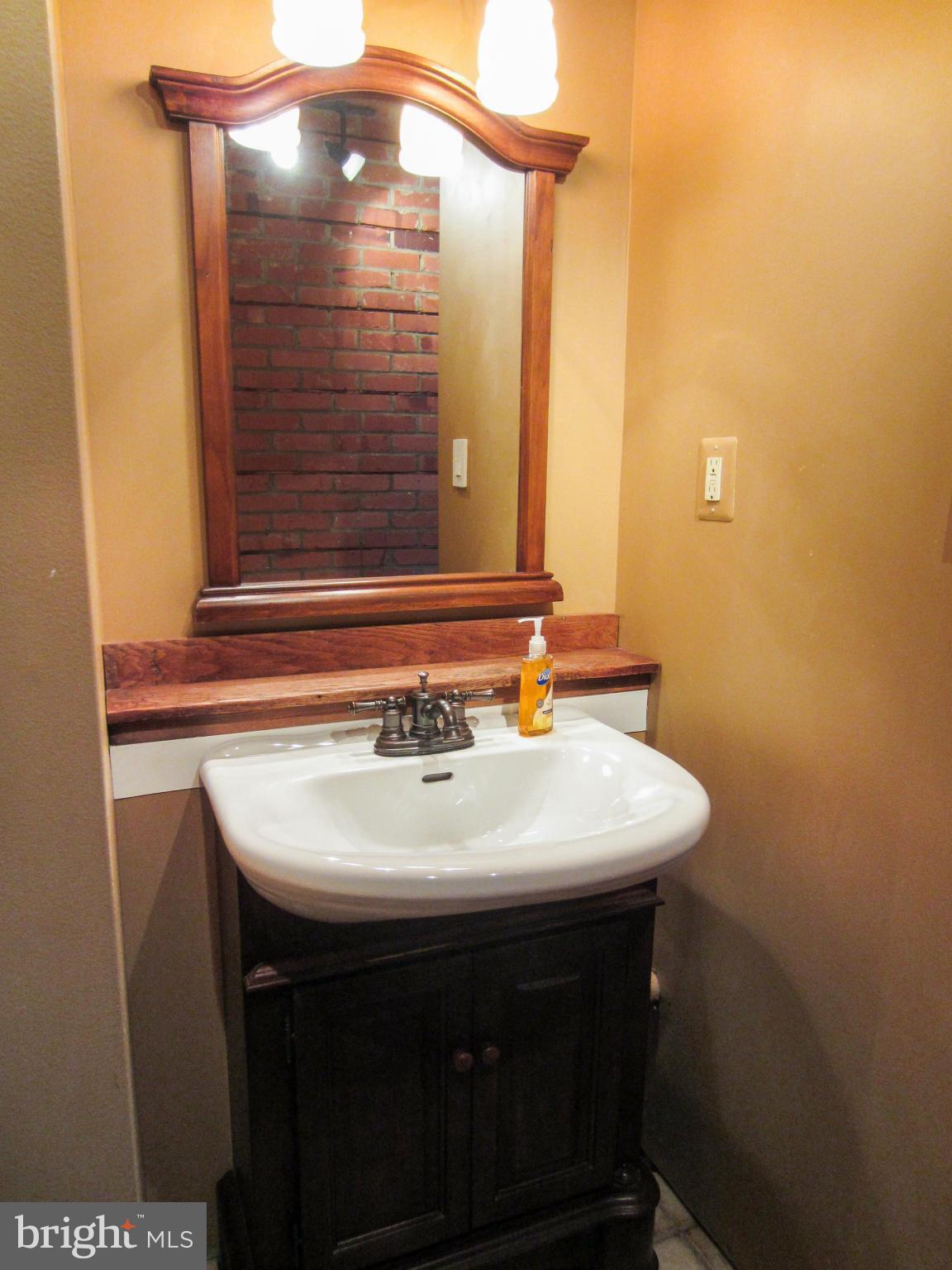 6042 Drum Point Road Deale, MD 20751 - Photo 14 of 21 a bathroom with a sink a mirror and a shower