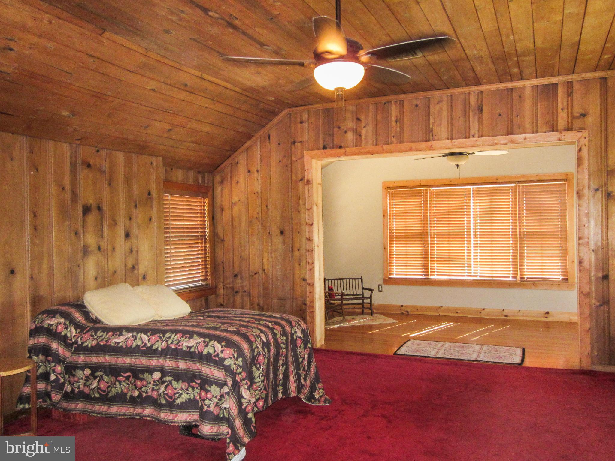 6042 Drum Point Road Deale, MD 20751 - Photo 19 of 21 a bedroom with a bed and wooden floor