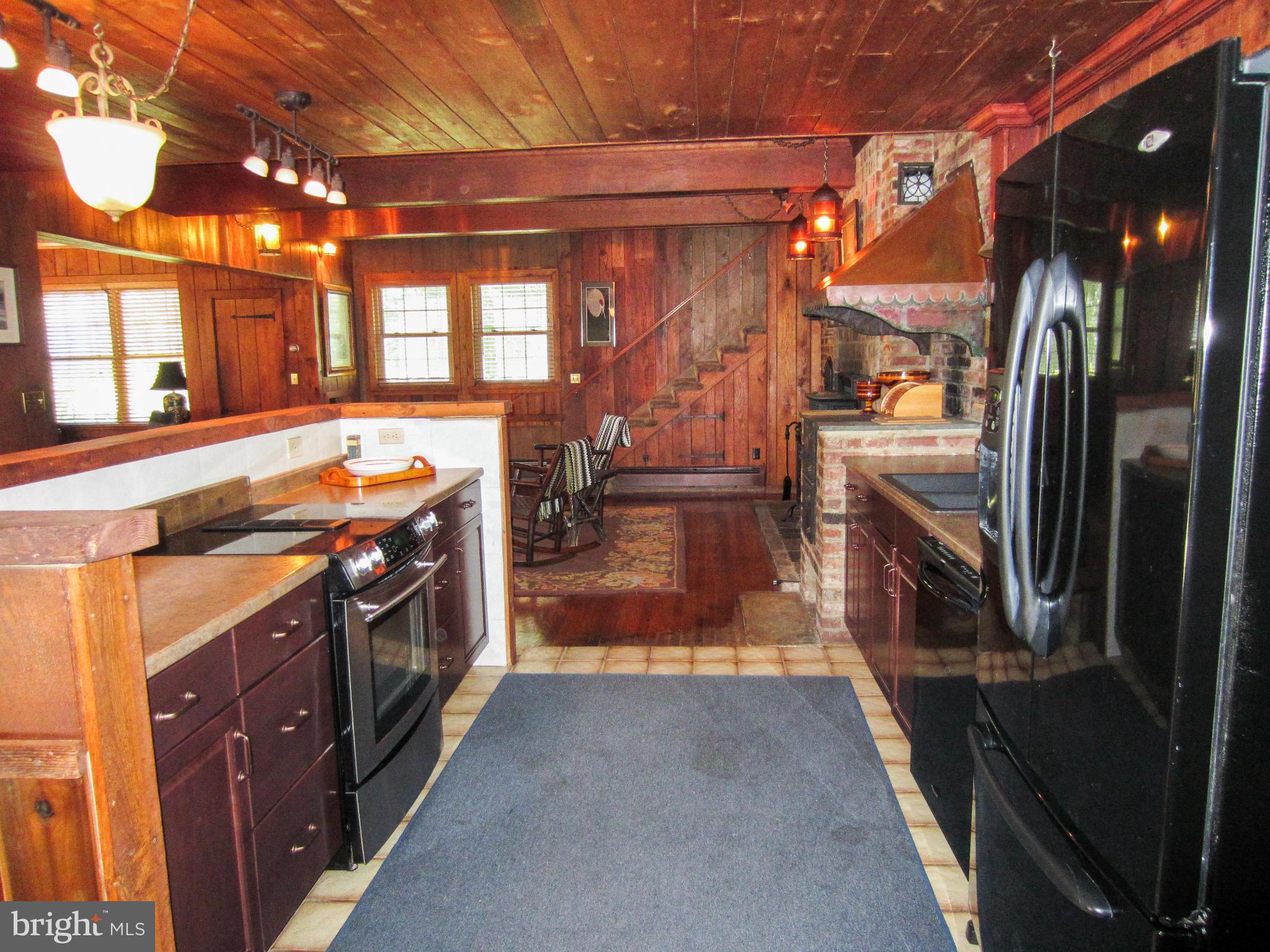 6042 Drum Point Road Deale, MD 20751 - Photo 9 of 21 a kitchen with stainless steel appliances granite countertop a refrigerator and a stove