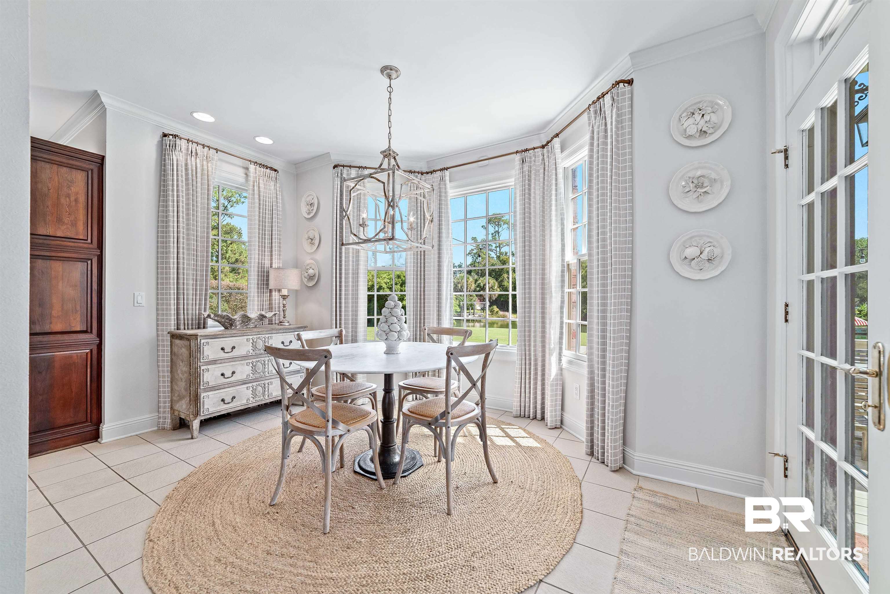 6630 East Quarry Drive Elberta, AL 36530 - Photo 8 of 63 Dining room with crown molding, light tile patterned floors, and a chandelier