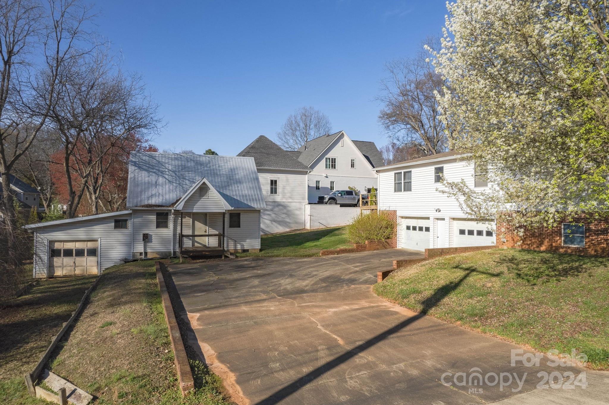 318 Walnut Street Davidson, NC 28036 - Photo 16 of 21 a view of a big house with a big yard and large tree