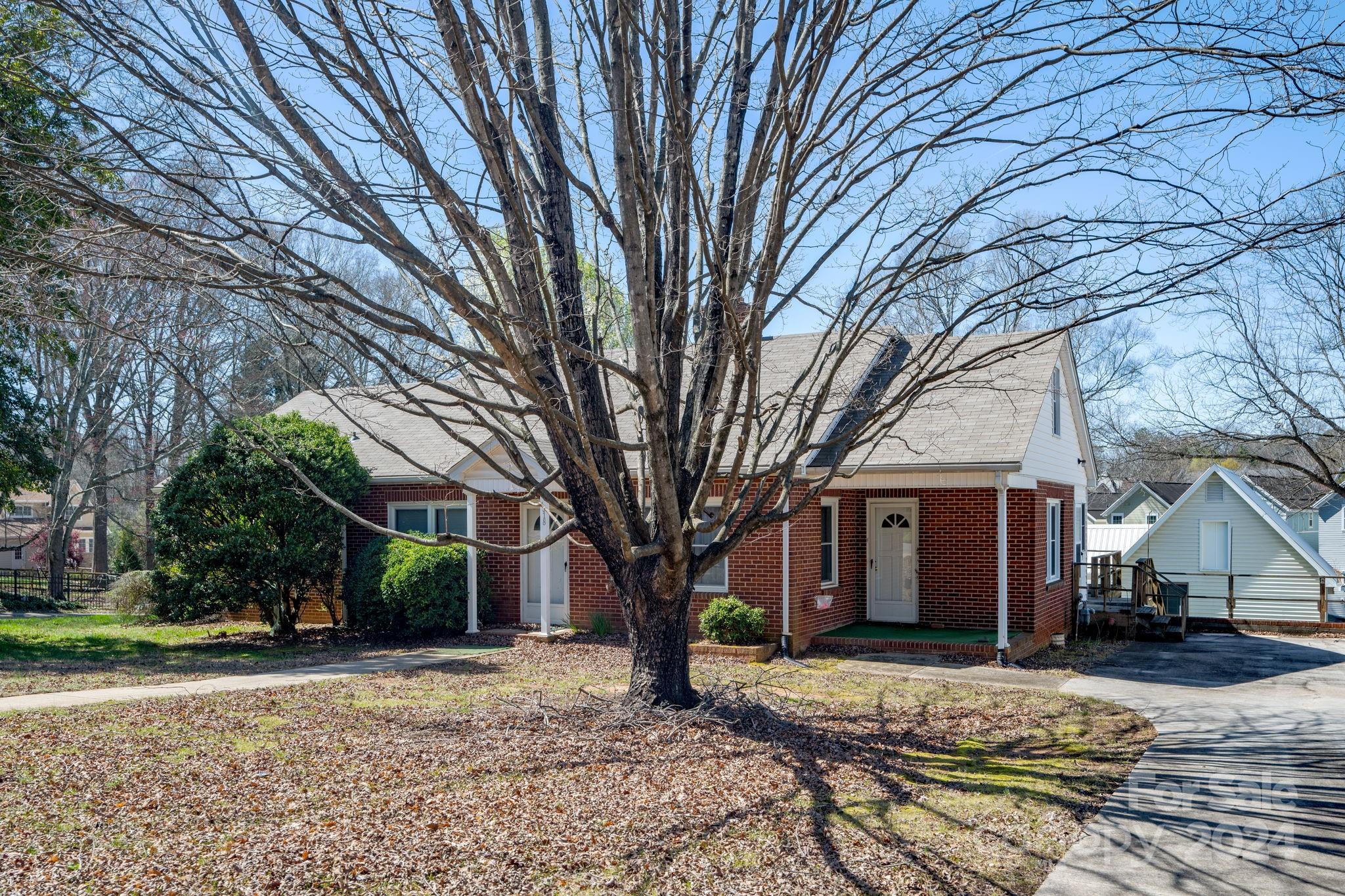 318 Walnut Street Davidson, NC 28036 - Photo 18 of 21 a view of a house with trees in the background