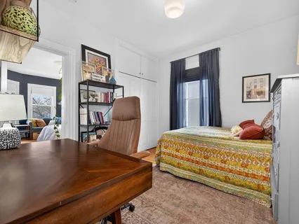a bedroom with furniture and a book shelf