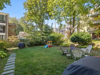 a backyard of a house with table and chairs
