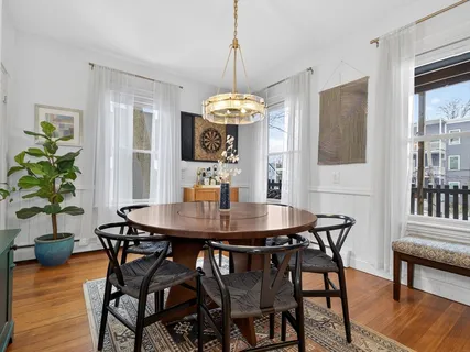 a dining room with furniture and window