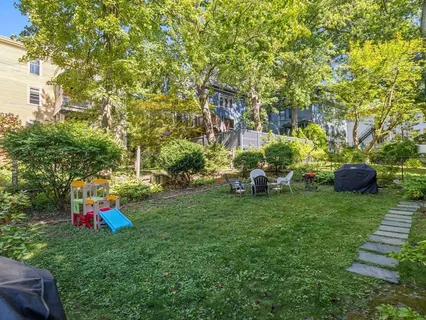a view of backyard of house and outdoor seating