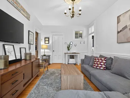 a living room with furniture and a flat screen tv