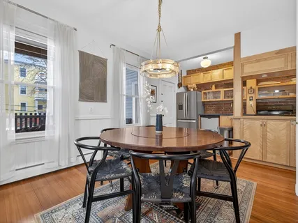 a view of a dining room with furniture and wooden floor