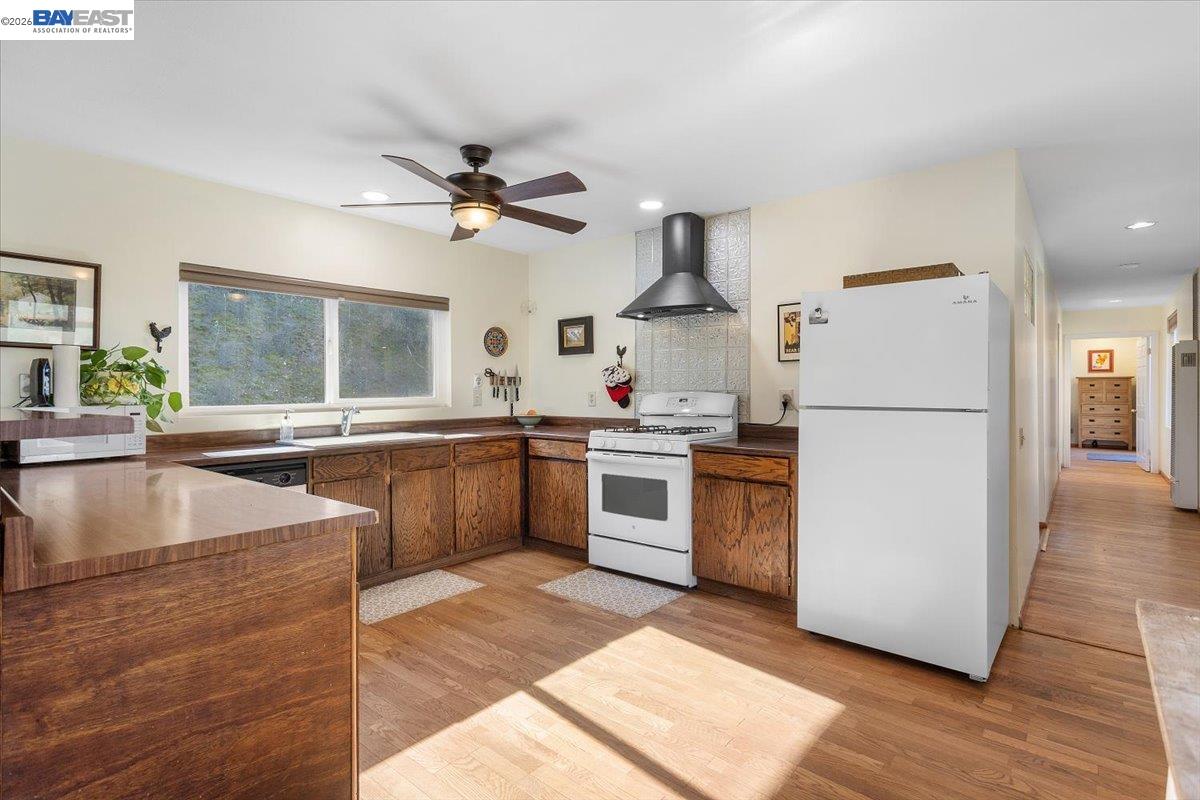 17370 West Corral Hollow Road Tracy, CA 95377 - Photo 7 of 43 a kitchen with a refrigerator sink and white cabinets