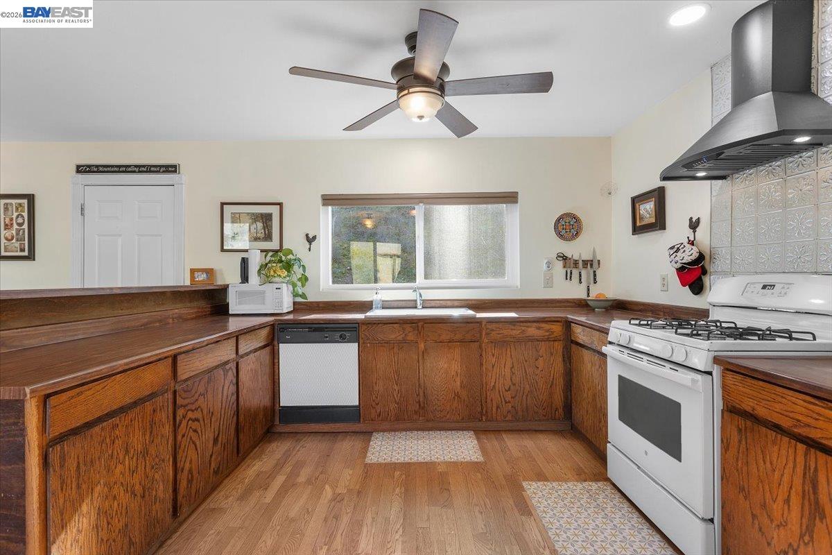 17370 West Corral Hollow Road Tracy, CA 95377 - Photo 8 of 43 a kitchen with stainless steel appliances granite countertop hardwood a sink stove and refrigerator