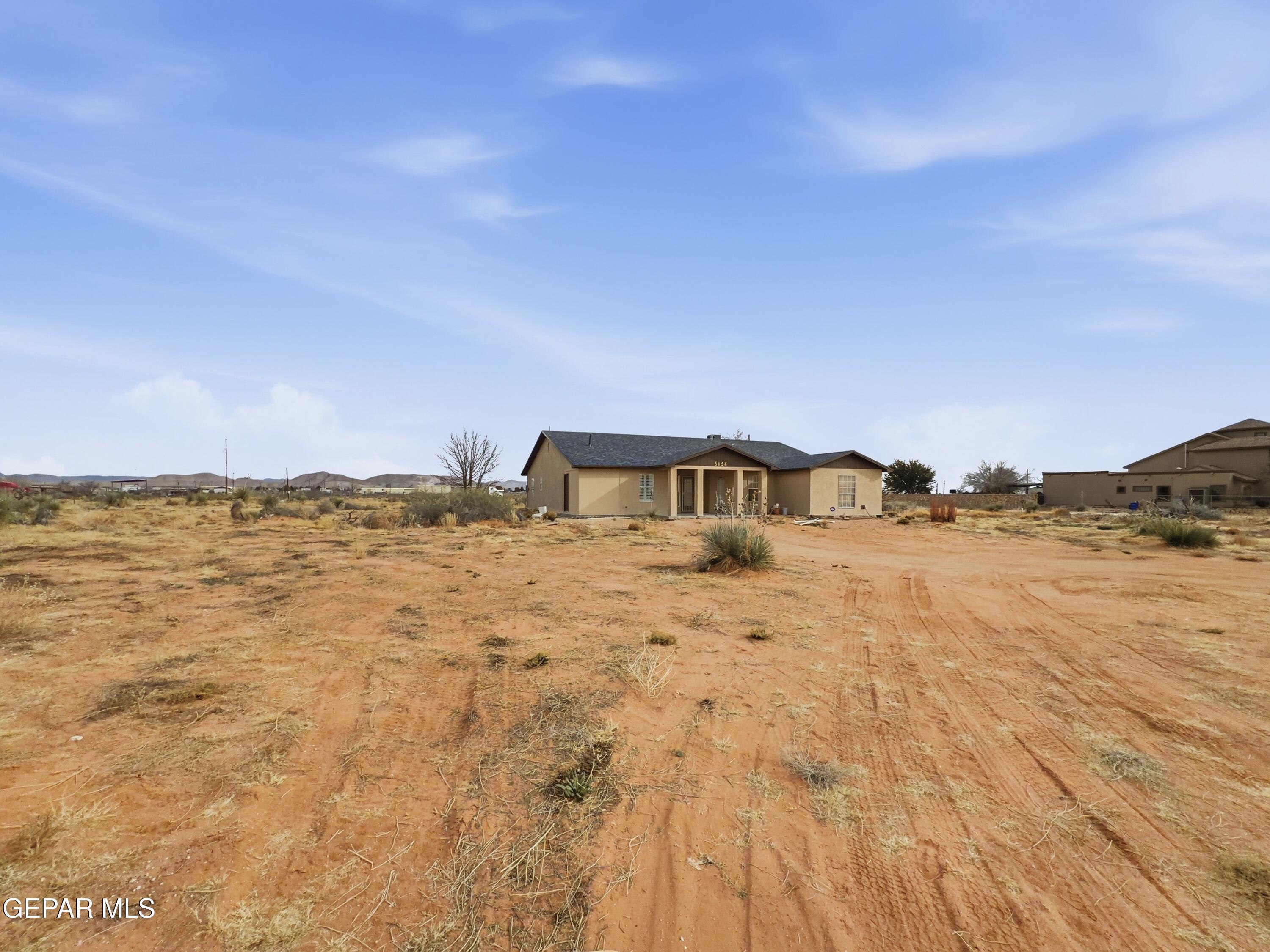 5156 Bradley Road El Paso, TX 79938 - Photo 2 of 39 a front view of a house with a lake