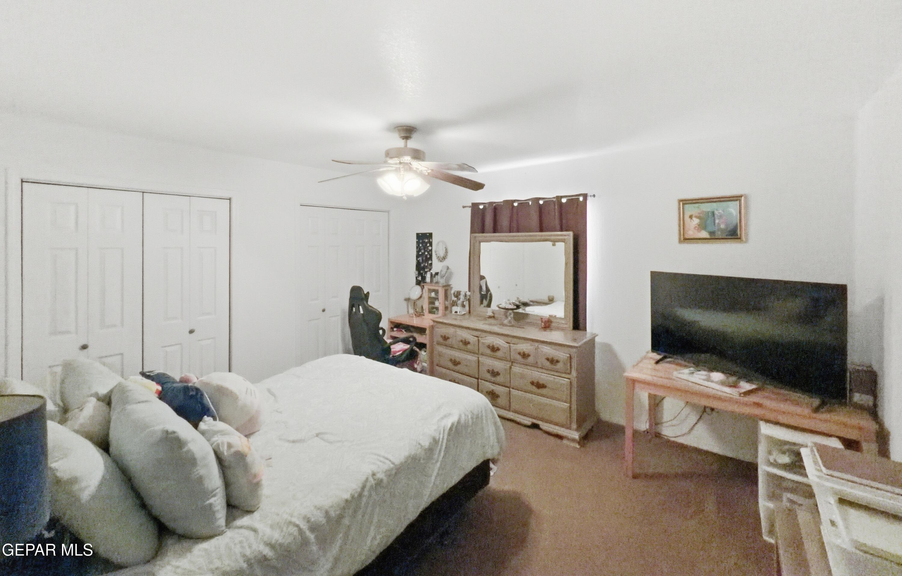 5156 Bradley Road El Paso, TX 79938 - Photo 24 of 39 a bedroom with a bed and a flat screen tv