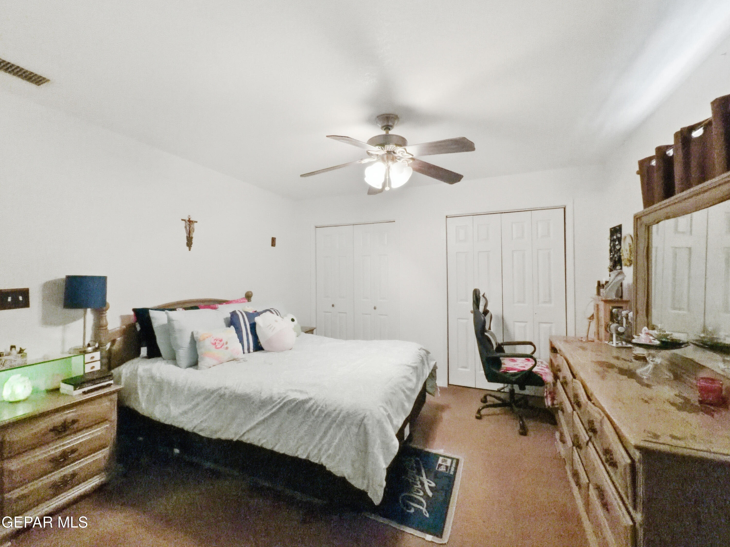 5156 Bradley Road El Paso, TX 79938 - Photo 25 of 39 a bed room with a bed furniture and a chandelier