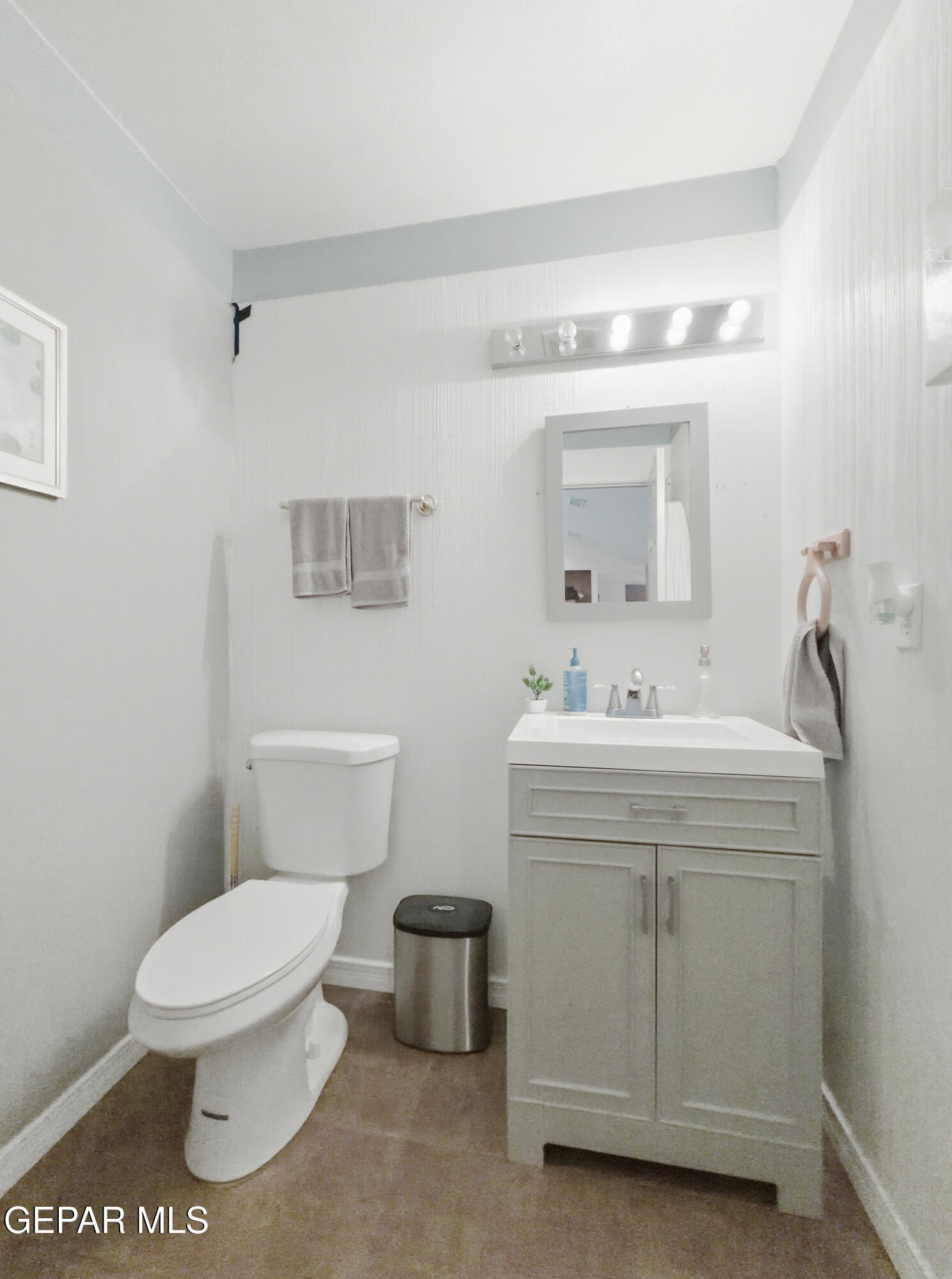 5156 Bradley Road El Paso, TX 79938 - Photo 32 of 39 a bathroom with a toilet sink and mirror