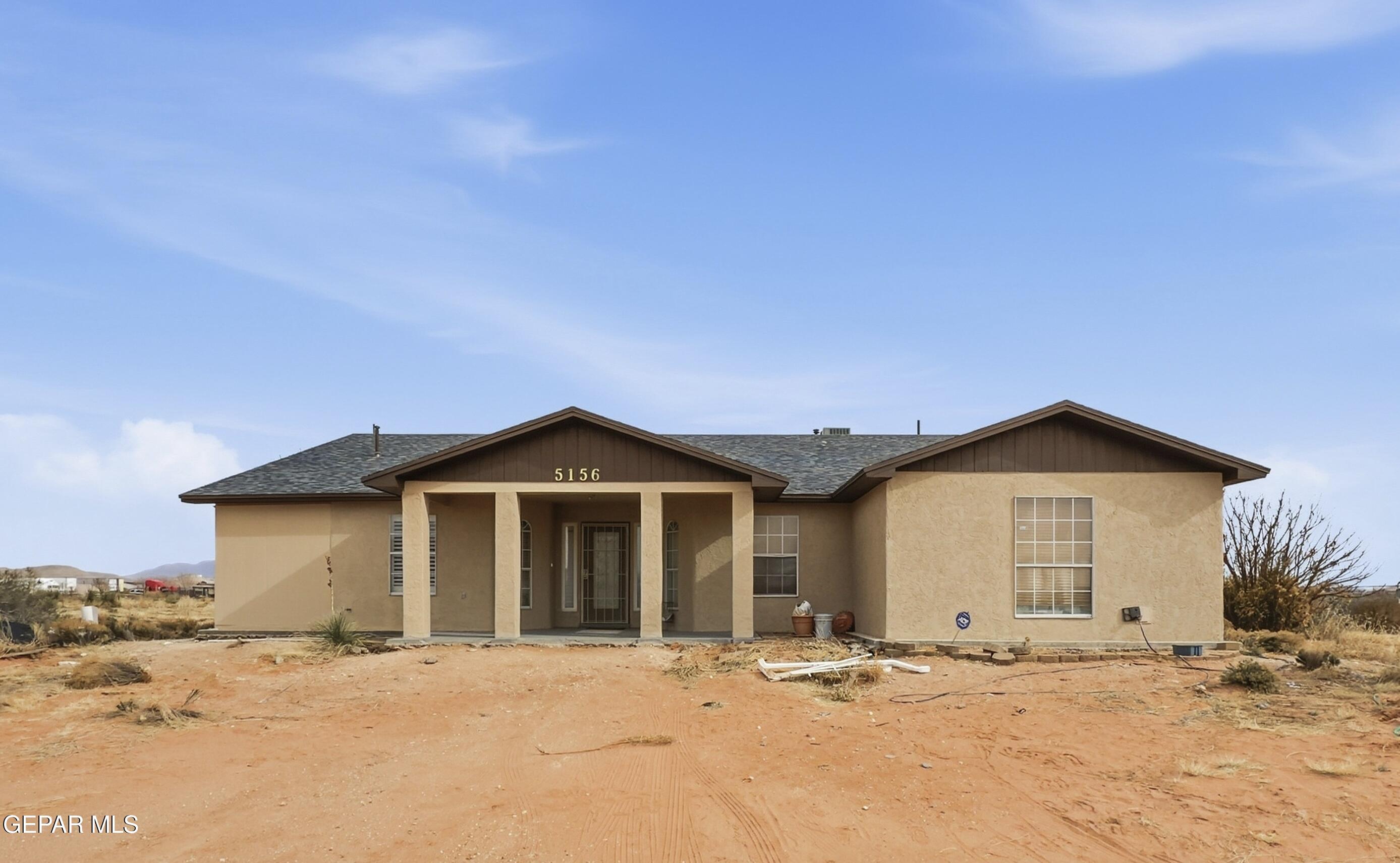 5156 Bradley Road El Paso, TX 79938 - Photo 39 of 39 a front view of a house with a dirt road and a wooden fence