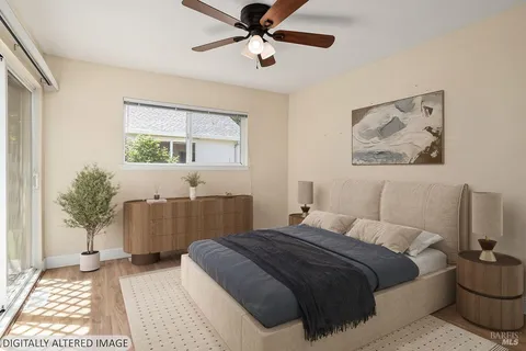 a bedroom with a large bed a chandelier and a window
