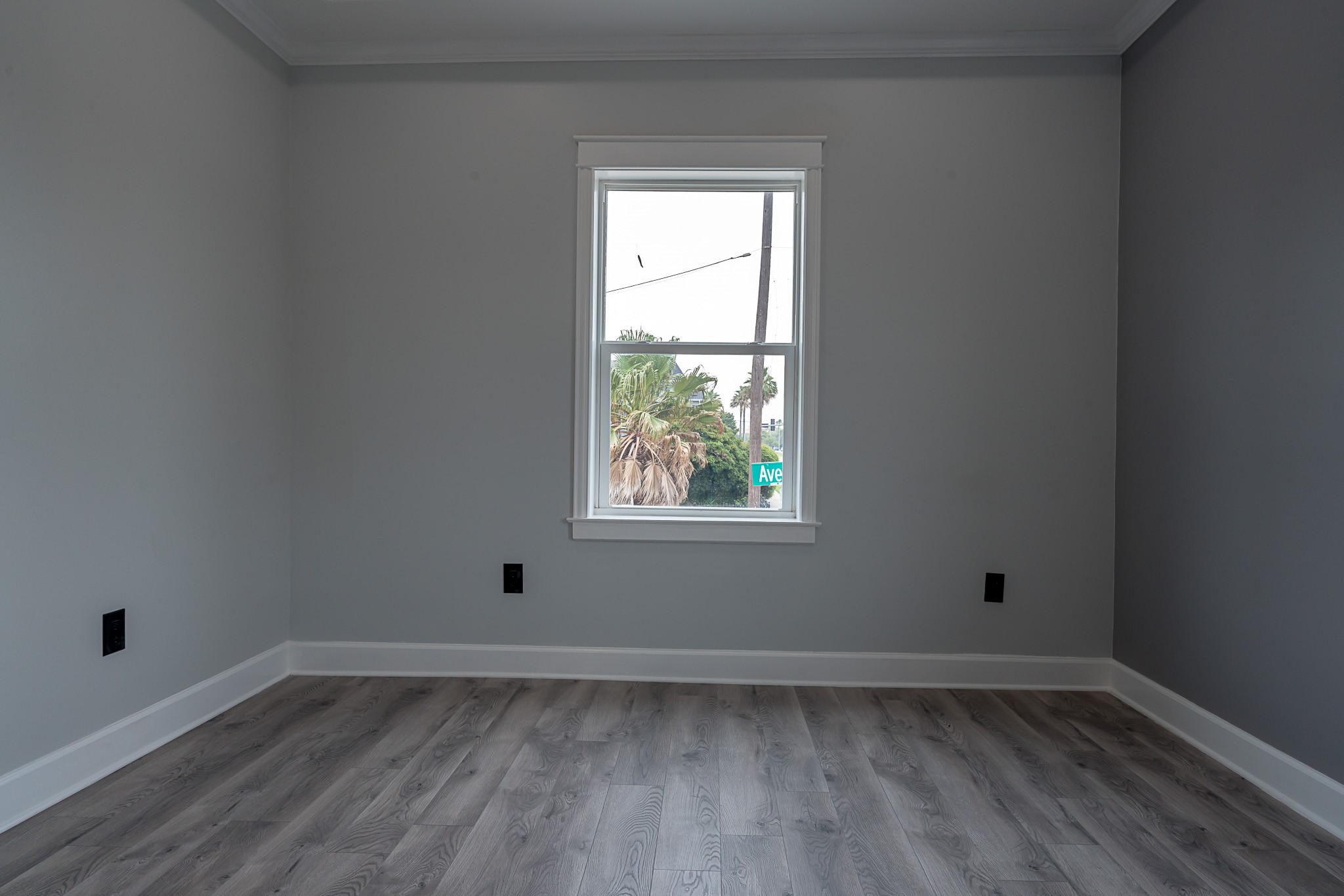 1801 Rosenberg Street, Unit 204 Galveston, TX 77550 - Photo 11 of 27 a view of an empty room with wooden floor and a window