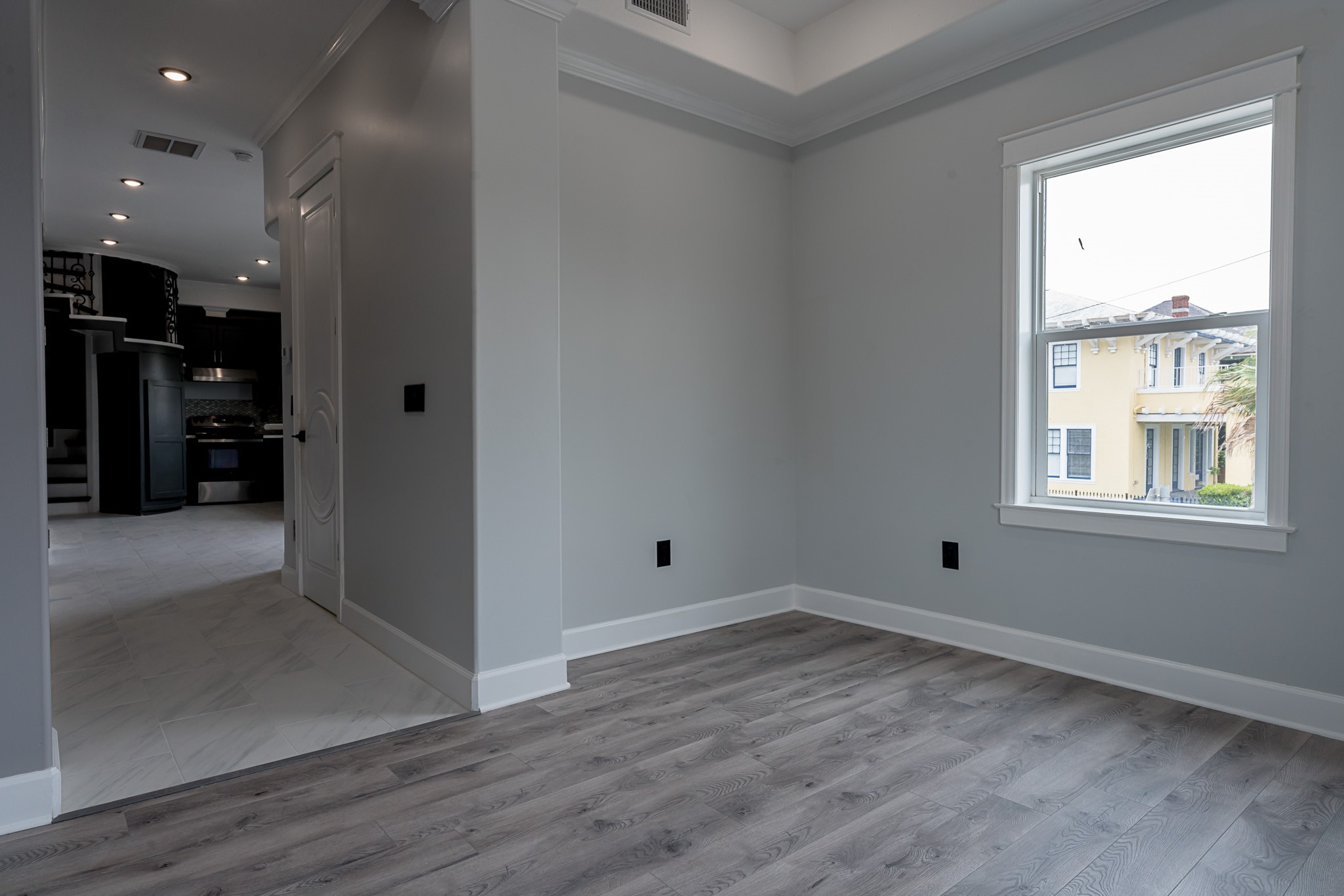 1801 Rosenberg Street, Unit 204 Galveston, TX 77550 - Photo 12 of 27 an empty room with wooden floor and windows