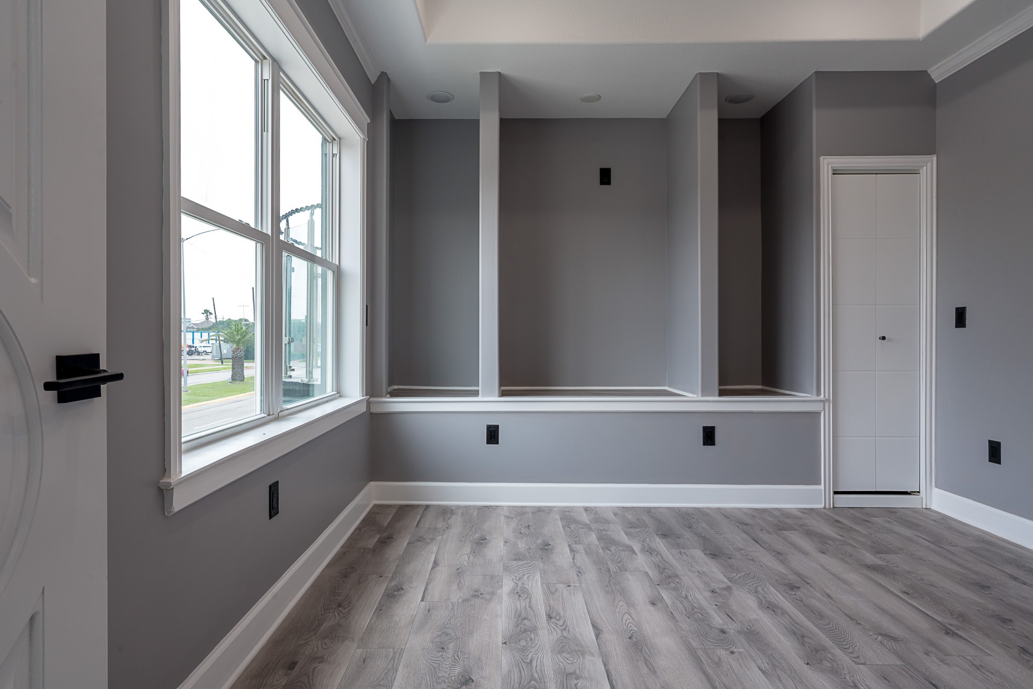 1801 Rosenberg Street, Unit 204 Galveston, TX 77550 - Photo 14 of 27 a view of an empty room with wooden floor and a window