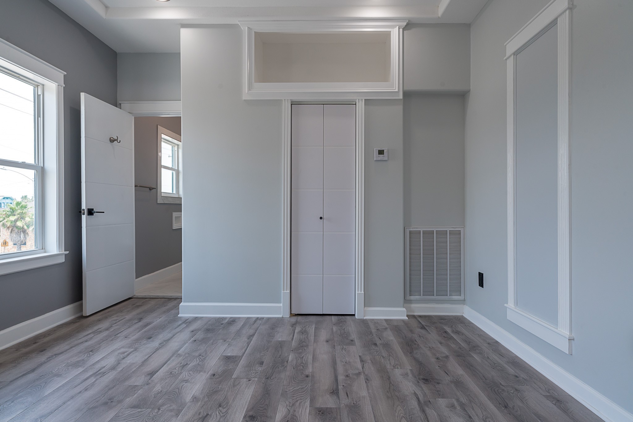 1801 Rosenberg Street, Unit 204 Galveston, TX 77550 - Photo 19 of 27 an empty room with wooden floor and windows