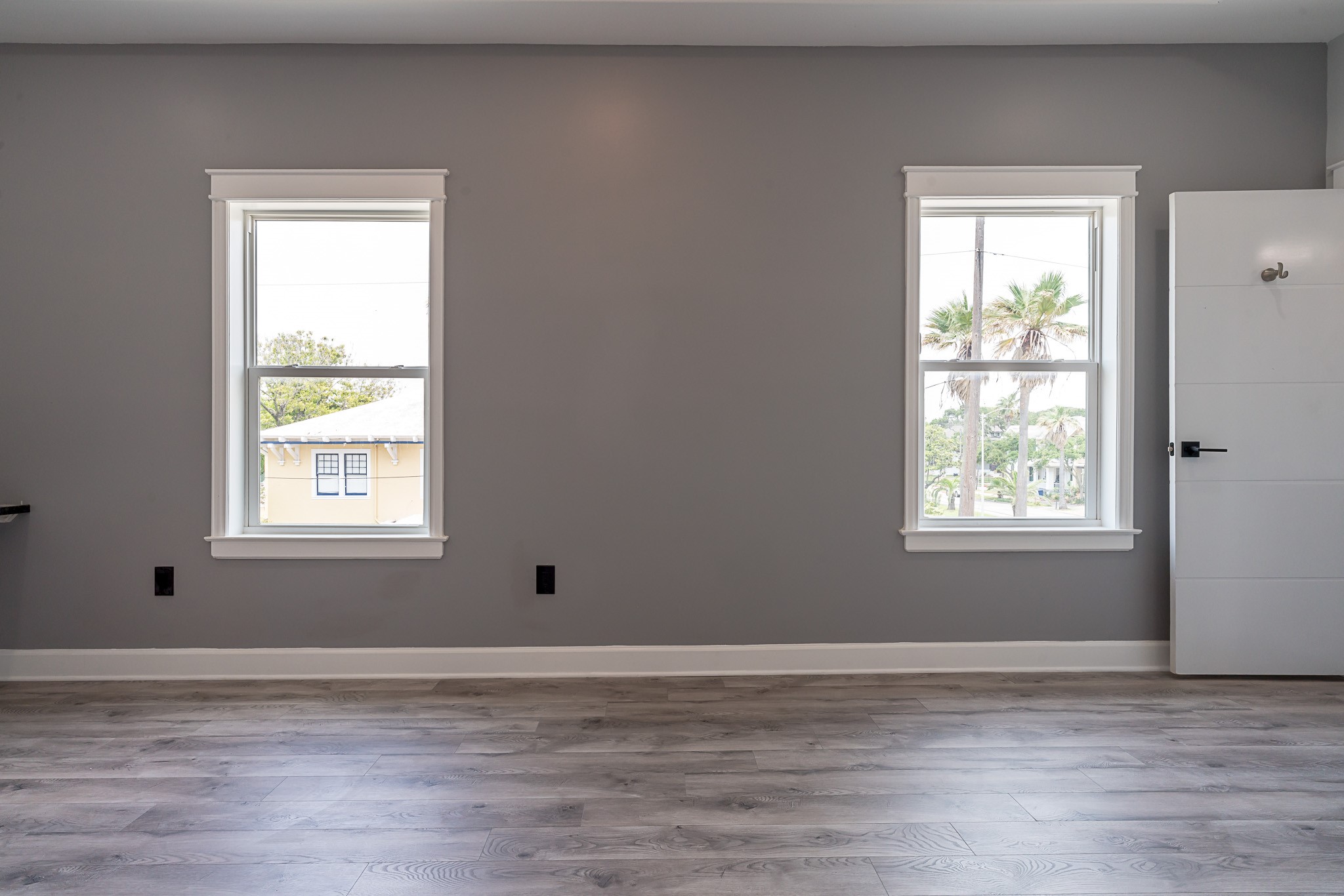 1801 Rosenberg Street, Unit 204 Galveston, TX 77550 - Photo 20 of 27 a view of empty room with wooden floor and windows