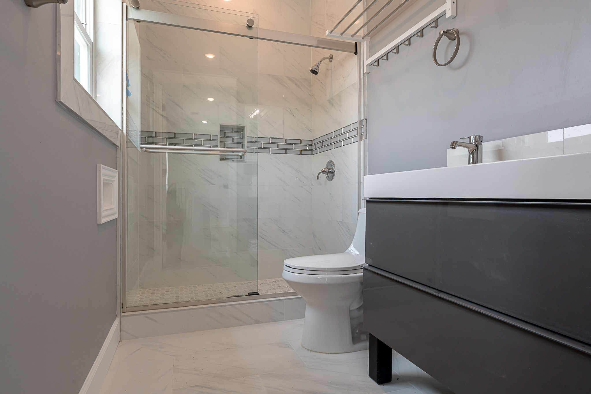 1801 Rosenberg Street, Unit 204 Galveston, TX 77550 - Photo 22 of 27 a bathroom with a shower a toilet and sink