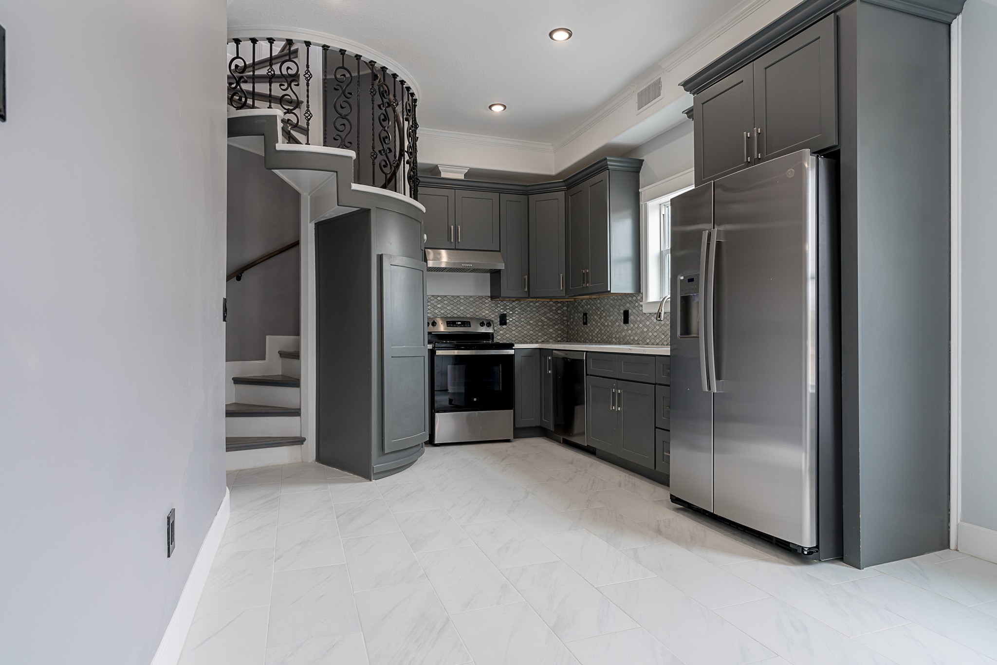 1801 Rosenberg Street, Unit 204 Galveston, TX 77550 - Photo 4 of 27 a kitchen with stainless steel appliances granite countertop a refrigerator and a stove