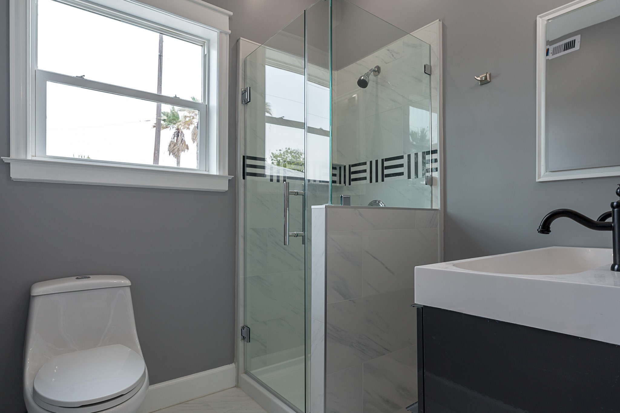 1801 Rosenberg Street, Unit 204 Galveston, TX 77550 - Photo 9 of 27 a bathroom with a toilet a sink and shower