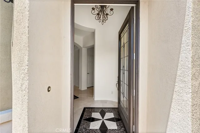 a view of a hallway with wooden floor and a livingroom