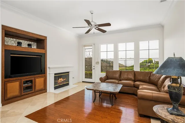 a living room with furniture and a view of kitchen