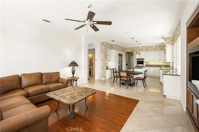 a kitchen with stainless steel appliances granite countertop a stove a refrigerator a kitchen island a table and chairs