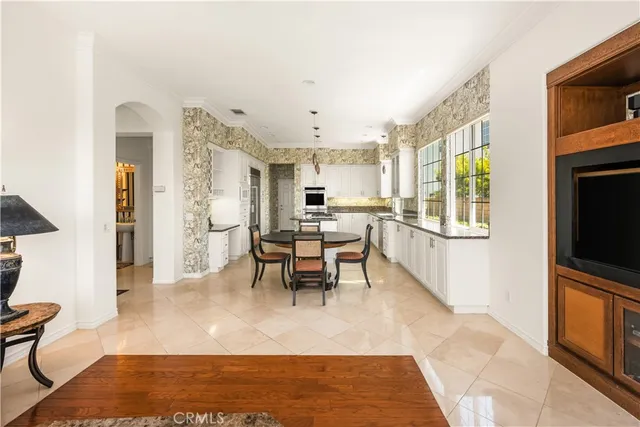 a large kitchen with kitchen island a sink table and chairs