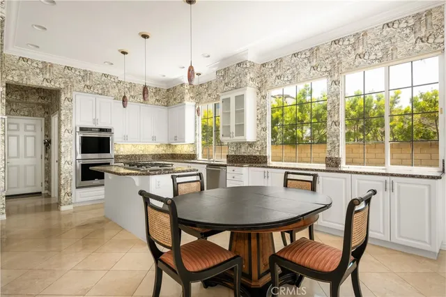 a kitchen with a refrigerator and a stove