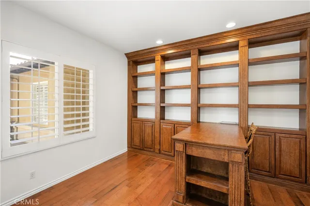a bedroom with a large bed and ceiling fan