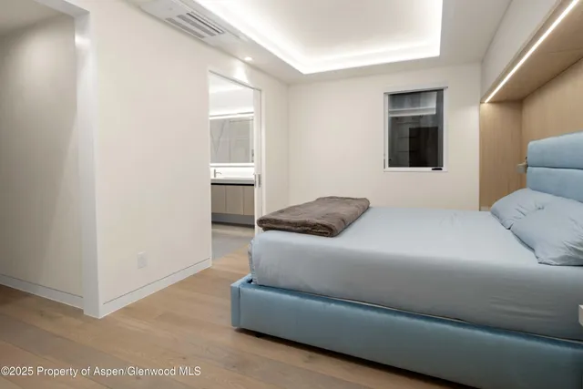 a bedroom with a bed and a potted plant