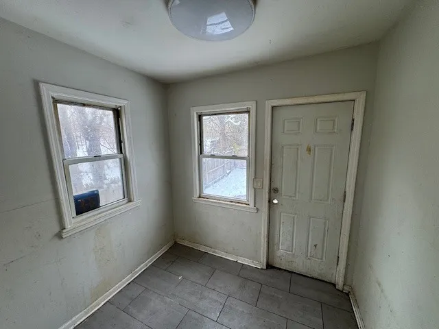 an empty room with windows and closet
