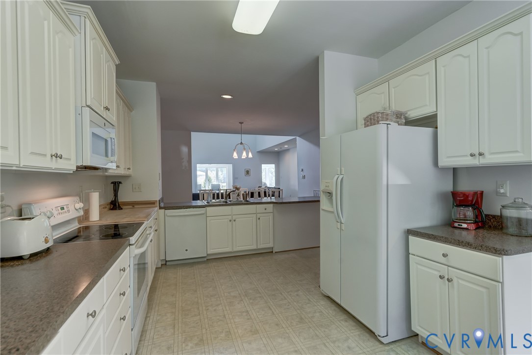 7902 Johnson Road Petersburg, VA 23805 - Photo 17 of 55 Kitchen featuring white cabinetry, built-in microw